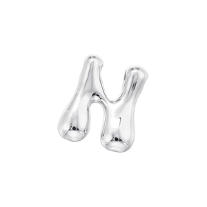 Macro view of polished silver metal letter N bead with glossy liquid metal finish