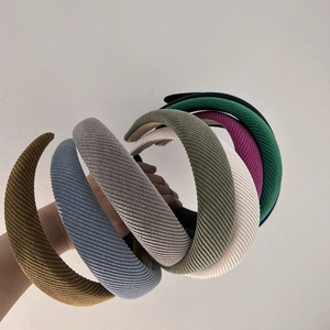 Close-up of multiple colorful twill fabric headbands in various solid shades