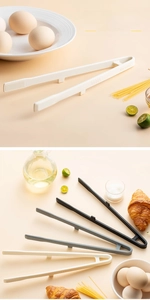 Detail of three silicone kitchen tongs in white, grey and black with non-slip texture
