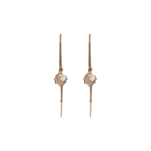 Minimalist rose gold long drop earrings featuring white cat eye stone on white background