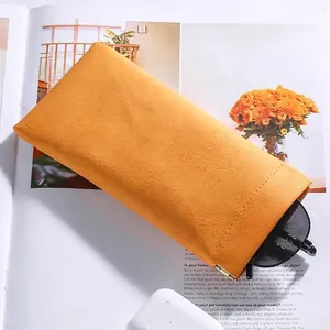 Mustard yellow pebbled leather sunglasses pouch with automatic metal closure and sleek design