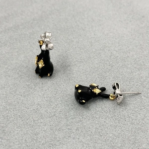 Stereoscopic black enamel bunny earrings with golden bow tie and gem details
