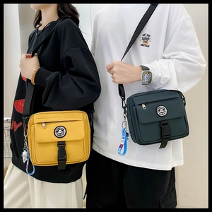 Close-up of yellow and green functional messenger bags with durable buckles and logo details