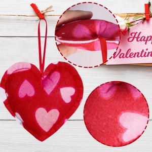 Detail of red felt heart ornament with pink prints and stitching for Valentine decoration