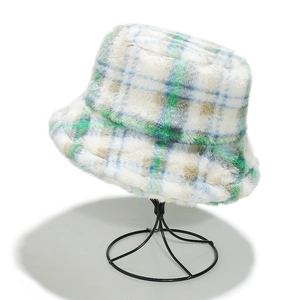 Detailed close-up of blue and green plaid faux fur bucket hat on a black metal stand