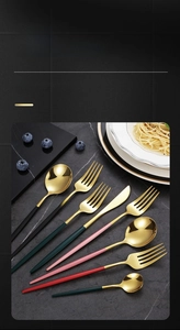 Detail of premium gold-plated stainless steel cutlery with colorful matte handles