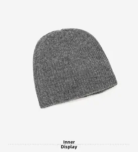 Detail view of the interior lining and dark gray knitted fabric texture of the beanie