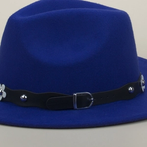Detailed close-up of blue wool felt jazz hat with rivet leather band and white petals