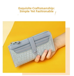 Close-up of light blue long wallet with crocodile pattern and multiple card slots