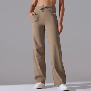 Detail view of high waisted drawstring waistband and side pockets on khaki yoga pants