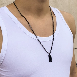 Men's black rectangular resin pendant necklace with thin metal chain on male model