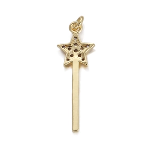 Macro detail of a gold star fairy wand pendant with intricate cutouts for DIY jewelry