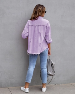 Detailansicht der lila Jeansjacke mit ausgefransten Kanten und zerrissener Rückenpartie
