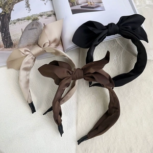 Elegant double-layered satin bow headbands in beige, brown, and black colors