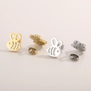 Detailed view of tiny bee earrings in gold and silver finishes with matching backs
