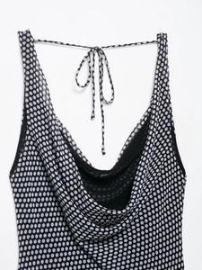 Detail of polka dot cowl neck top showing lightweight fabric and back tie closure