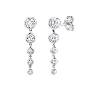 Detail of silver-tone drop earrings featuring five graduated bezel-set round zircons