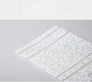 Macro shot of 5D white lace flower nail stickers with thin adhesive backing
