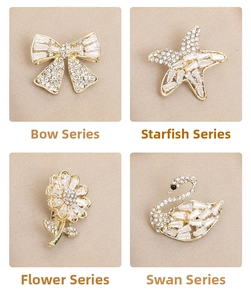 Detailed close-up of bow, starfish, flower and swan brooches with sparkling zircon stones
