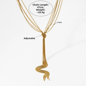 Close-up of gold layered chain necklace with a knotted design and tassel details