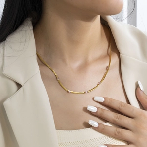 Detail of 18K gold plated snake chain necklace with pink square cubic zirconia stones