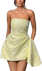 Detailed close-up of light yellow jacquard fabric and ruched side drape on mini dress