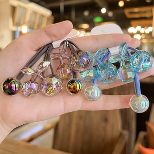 Detail of handmade cherry pendants on elastic hair bands with crystal gradient colors