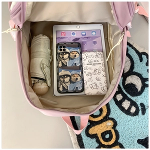 Internal view of pink nylon school backpack showing large capacity and organizer pockets