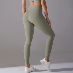 Close-up of high-waisted sage green yoga pants featuring a seamless back-lifting design