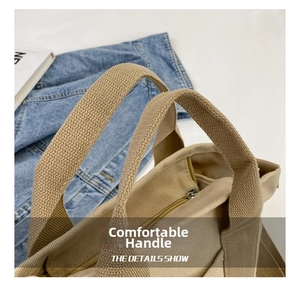 Close-up of durable canvas tote with reinforced handle and smooth metal zipper detail