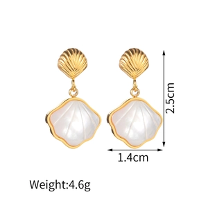 Detailed view of shell earrings with gold frames, 2.5cm height and 1.4cm width dimensions