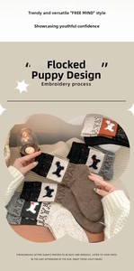 Close-up of Fair Isle style wool socks featuring detailed cute puppy embroidery craft