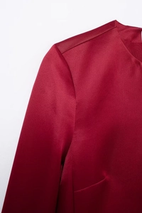 Close-up of wine red satin blouse showing elegant shoulder details and silky fabric