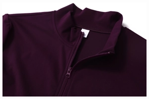 Detailed close-up of smooth half-zipper and stand collar on purple yoga sports jacket