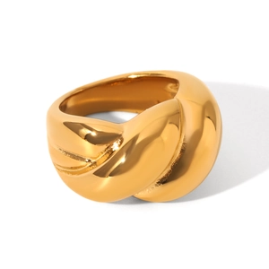 Macro shot of twisted croissant style gold ring showing metallic texture and polished finish