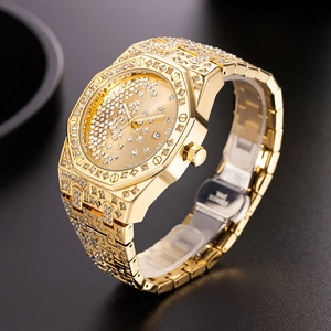 Macro shot of luxury gold watch featuring full iced-out crystals and octagonal bezel