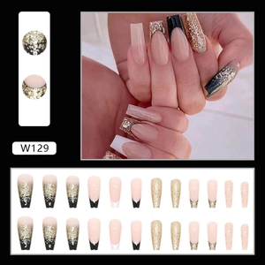 Long coffin press-on nails with black French tips and champagne gold glitter accents