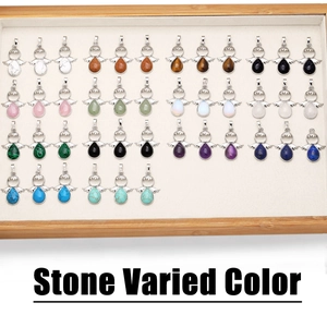 Detailed array of wing-shaped crystal and agate teardrop pendants in various natural stones