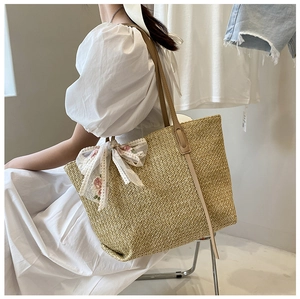 Straw tote bag with delicate white lace bow and pink floral embroidery detail