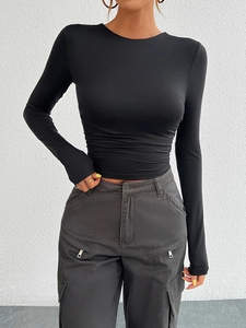 Close-up of black slim fit crop top with long sleeves and round neck for women