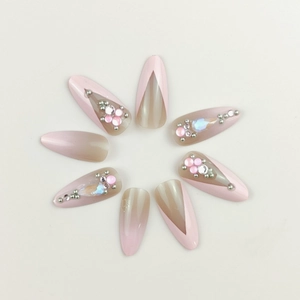 Pink French press-on nails with sparkling glitter and rhinestones in stiletto shape