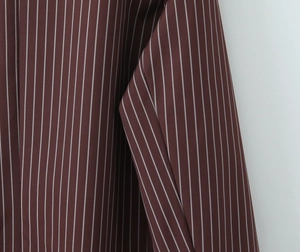 Detailed close-up showing the brown striped fabric texture and vertical pattern