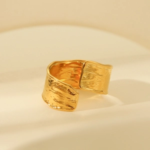 Detail of 18K gold plated wide ring featuring hammered texture and adjustable open band