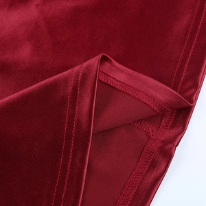 Macro shot of red satin dress stitching detail featuring smooth double-needle flat seams