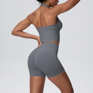 Detail of high-waisted seamless yoga shorts and halter sports bra in charcoal gray