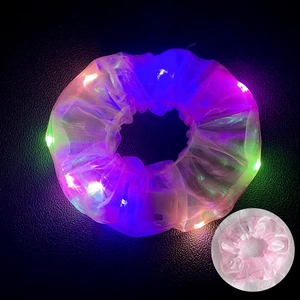 Detail of LED glowing hair scrunchie made of sheer mesh fabric with colorful lights