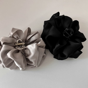 Elegant French satin bow hair clips in black and silver grey on a white background
