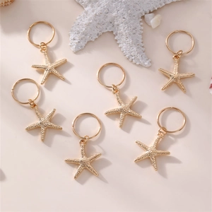 Detailed view of golden starfish hair accessories with shells on a beach theme background