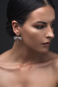 Minimalist silver dragonfly earrings with hand-hammered texture on high-end model