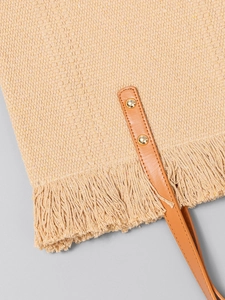 Beige woven canvas tote bag with brown faux leather straps and fringe detail